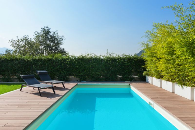 home private pool with two pool lounge chairs